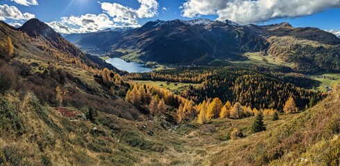 beautiful autumn hike above lake davos. Colored larch forests. Mountain panorama in Davos Klosters Mountains. High quality photo