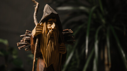 Wooden figurine of an old traveler in the forest collecting firewood: wood, wooden figurine,...