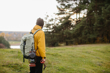 A hiker walking in nature carrying backpack