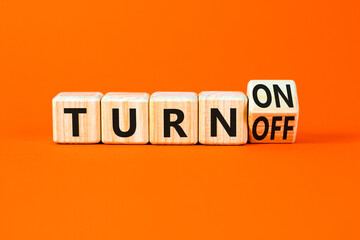 Turn on or off symbol. Concept words Turn off and Turn on on wooden cubes. Beautiful orange table orange background. Business Turn on or off concept. Copy space.