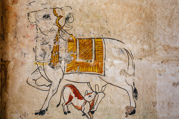 Colorful mural of a mother cow and a calf on a wall in Bundi, Rajasthan, India, Asia