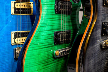 Blue, green and black electric guitars close-up. Musical instruments