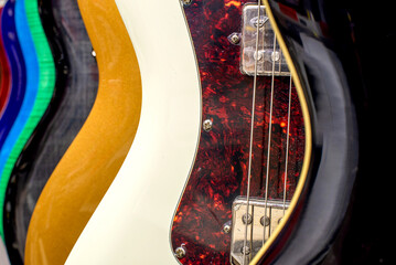 Background of multicolored guitars. Electric guitars close-up