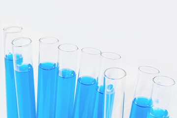 Transparent glass test tubes on a white background, blue liquid, chemical element, catalyst, laboratory, medical equipment, glass, chemistry, biochemistry, chemical laboratory, template, for medicine,