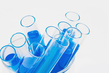 Transparent glass test tubes on a white background, blue liquid, chemical element, catalyst,...