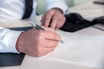 Close up of businessman signing a contract. Business concept