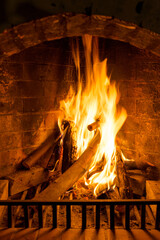 Burning woods in a brick fireplace