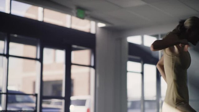 Low angle view of woman practicing contemporary dancing in dance studio / Lehi, Utah, United States