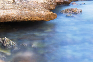 Water is blurry at long exposure. Beautiful stone in the background