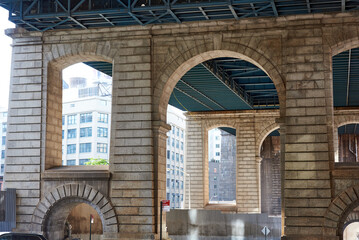 The granite structural supports of the Manhattan bridge on Pearl St in the Dumbo neighborhood of Brooklyn, NYC.