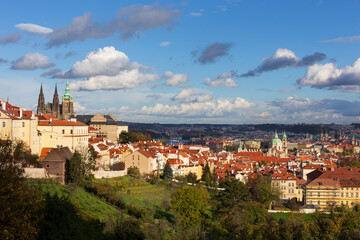 Fototapeta premium Autumn Prague City with gothic Castle, colorful Nature and Trees and dramatic Sky from the Hill Petrin, Czech Republic
