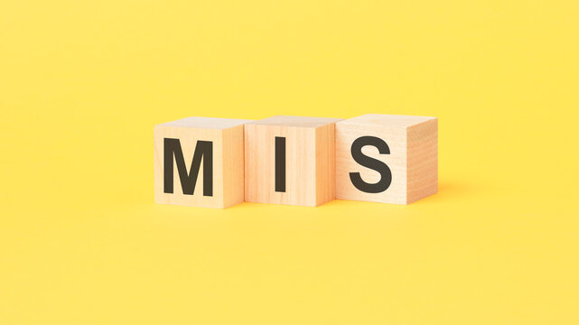 mis - text on wooden cubes, on yellow background. management information system concept