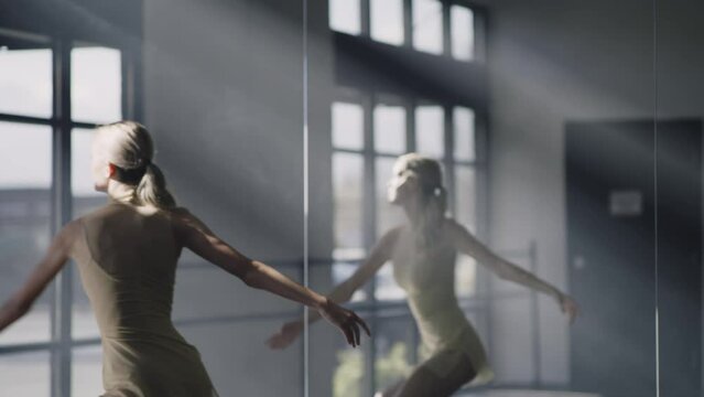 Low angle view of woman practicing contemporary dancing in dance studio / Lehi, Utah, United States