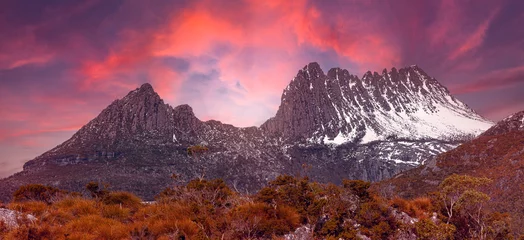 Cercles muraux Mont Cradle Landscape view sunset glow through the clouds of  mountains peak perfect background to the spectacular snow-capped Cradle Mountain, Tasmania,Australia.