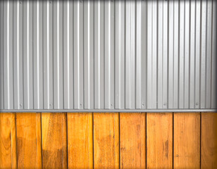 Grey , shiny, smooth corrugated aluminium sheeting at the top against the natural, rough uneven texture of the timber planks at the bottom.