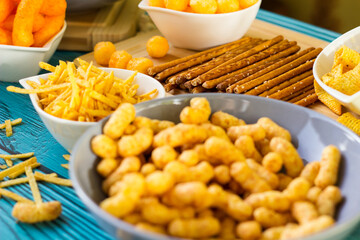 Beer salty snacks on wooden table