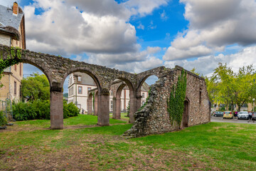 Fototapeta na wymiar The remains of the cloister in the ruins of the 17th century Abbey of Saint Gregory in the village of Munster, France, in the Alsace region.