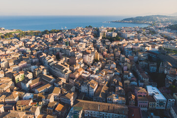 Obraz premium Kerkyra city, Corfu island, Greece, beautiful summer aerial drone view of Kerkyra old town center, with Ionean sea harbour port, Saint Spyridon Church, the Royal Palace and scenery beyond the city