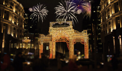 Fireworks for 2023 new year celebration.Street decorated for Christmas holidays. Large lightened gates with ornament.