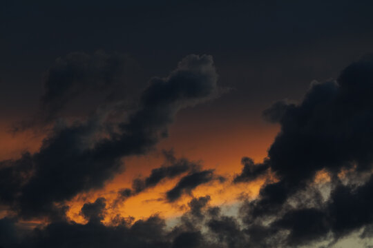 Dark clouds in a colorful sunset sky
