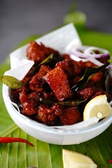 Homemade chicken 65 or chilli chicken fry served in a bowl, selective focus
