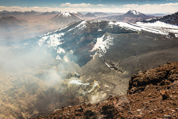 Atacama desert, snowcapped Lascar volcano crater and arid landscape in Chile © Aide