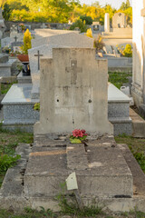 Old tombstone, adorned with flowers
