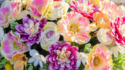 Close-up of a bouquet of artificial flowers, pink, yellow, purple