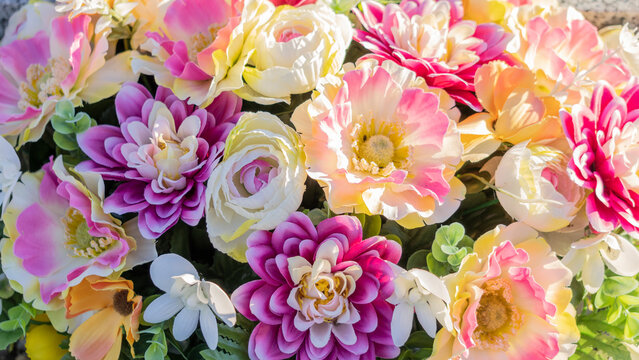 Close-up of a bouquet of artificial flowers, pink, yellow, purple © Natura