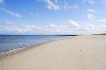 Horizon landscape of beach with calm ocean water, jetty, no people. Scusset Beach State Reservation October 2022.