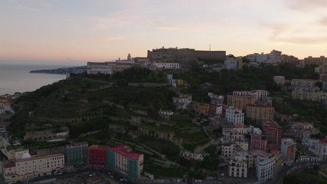 Aerial View Of Historic Fortified Castle Castel SantElmo On Hill Above City. Revealing Sea Coast At Dusk. Naples, Italy