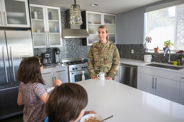 Air Force service member having breakfast with kids before work.