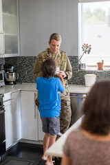 Air Force service member having breakfast with kids before work.