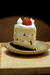 Close up of delicious fruit cake with strawberry and cream
