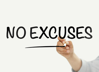 Businessman writing "no excuses" on a transparent board
