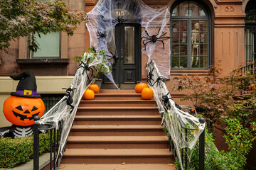 Front of apartment building decorated with spider web for Halloween holiday in Manhattan New York....