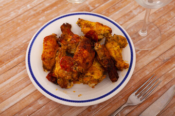 Appetizing crispy deep fried chicken wings served on plate. Popular snack