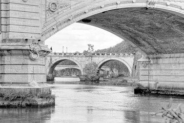 Bridges crossing the Tiber river in Rome Italy on a fall day. - obrazy, fototapety, plakaty
