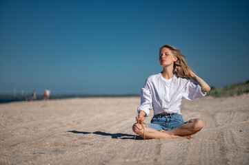 Girl practice meditation on the beach. With space for text or design