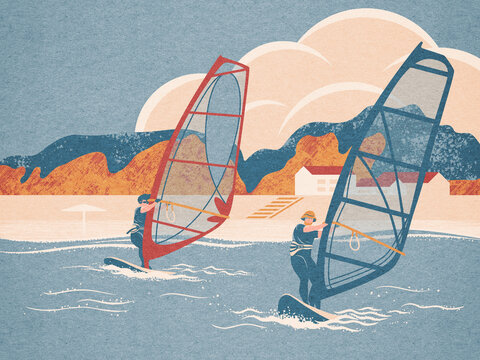 A couple playing windsurfing on the sparkling sea
