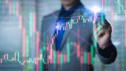 Businessman pointing on candlestick graph growth