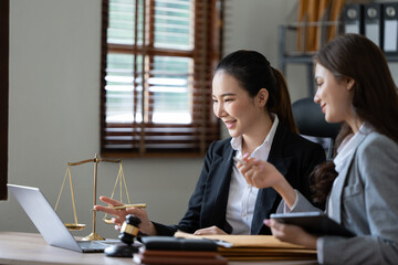 Lawyer office. Statue of Justice with scales and lawyer working on a laptop. Legal law, advice and justice concept.