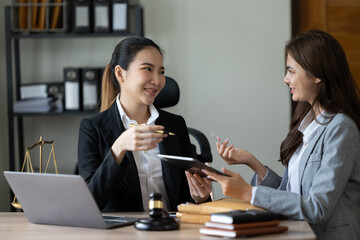 Lawyer office. Statue of Justice with scales and lawyer working on a laptop. Legal law, advice and justice concept.