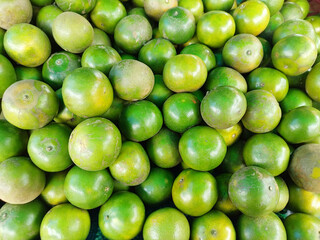 Green Orange, Tropical Fruits Background. Green Orange in store Farmer's Market Organic.