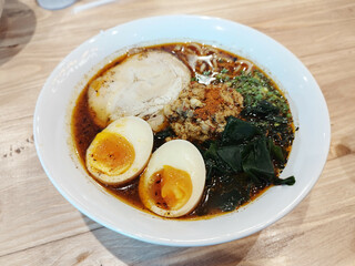Spicy Miso Ramen with Chashu pork slide, Wakame seaweed, Boiled egg and minced pork. Japanese food.