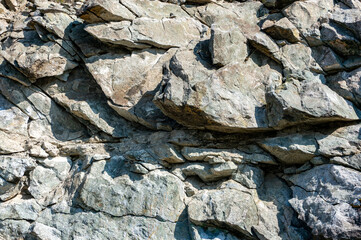 Background, texture rough stones of a stone cliff
