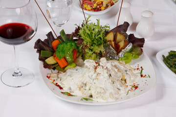 Vegetarian appetizers with red wine on the dinner plate.
