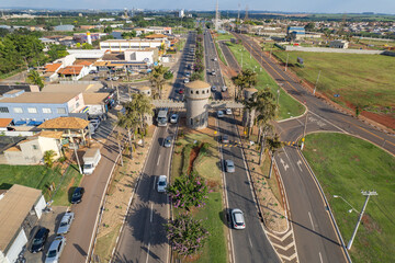 Paulinia, Sao Paulo, Brazil. October 25 2022: Portal of the city of Paulínia in the interior of São Paulo. Cars, city entrance and castle style portal.