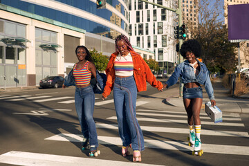 Portrait of young friend group rollerskating together in the city smiling 
