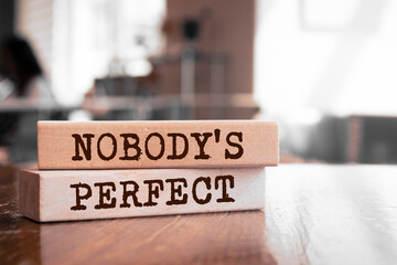 Wooden blocks with words 'Nobody's Perfect'.